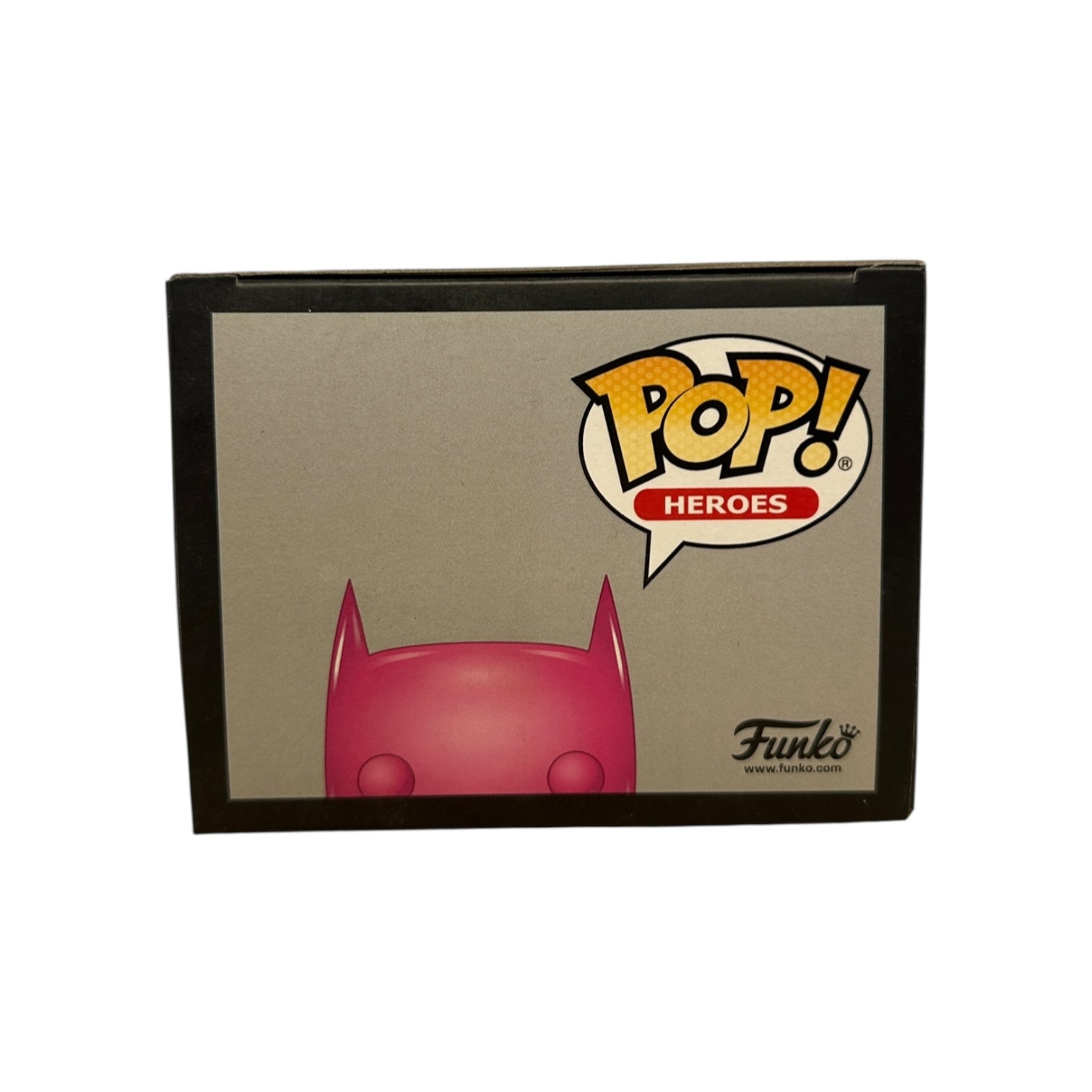 Funko Pop! Heroes box with a red character silhouette on a beige background
