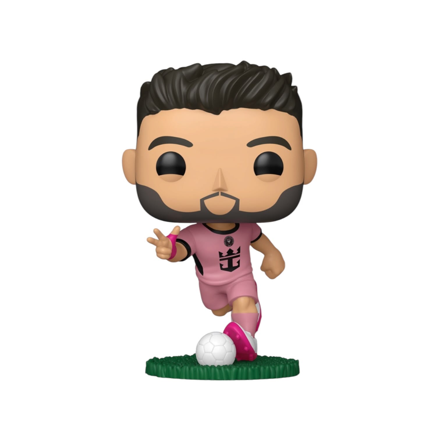 A stylized vinyl figure of a soccer player with dark hair and beard, wearing a pink jersey and shorts with bright pink socks, standing on a green grass base next to a white soccer ball against a plain white background.