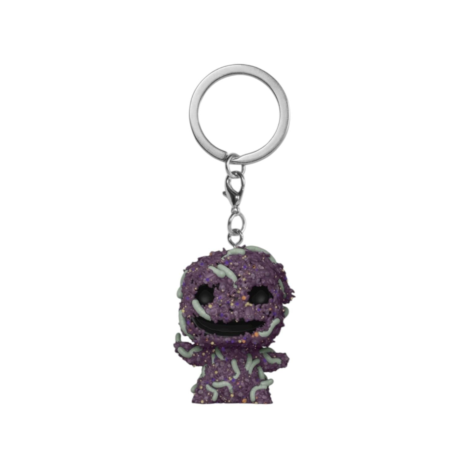 Purple glittery keychain with a character design on a white background
