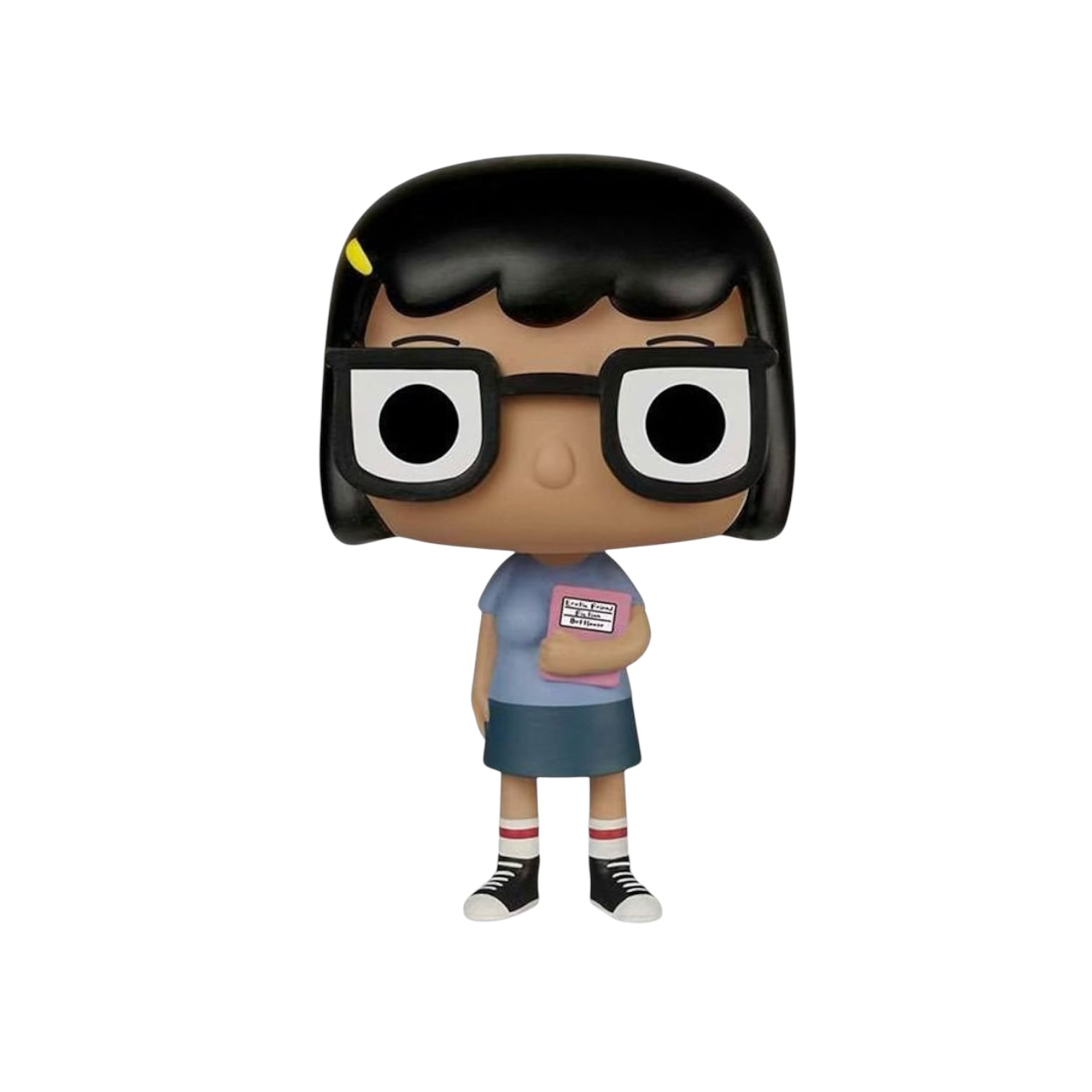 Tina Belcher with short black hair, black framed glasses, a blue short sleeved top and blue skirt holding a pink book.