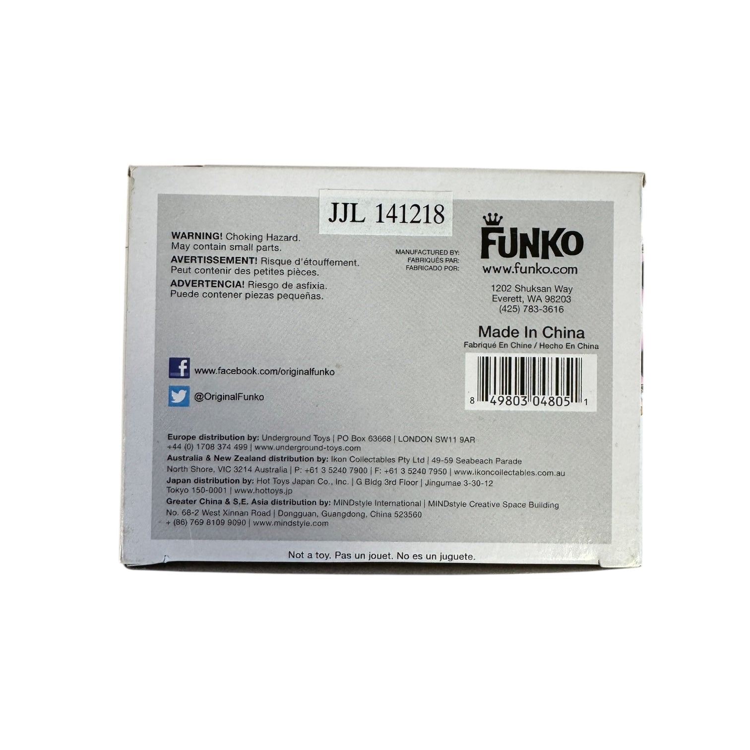 Woman wearing red dress, green and hold head piece and blue and pink eye make up. 