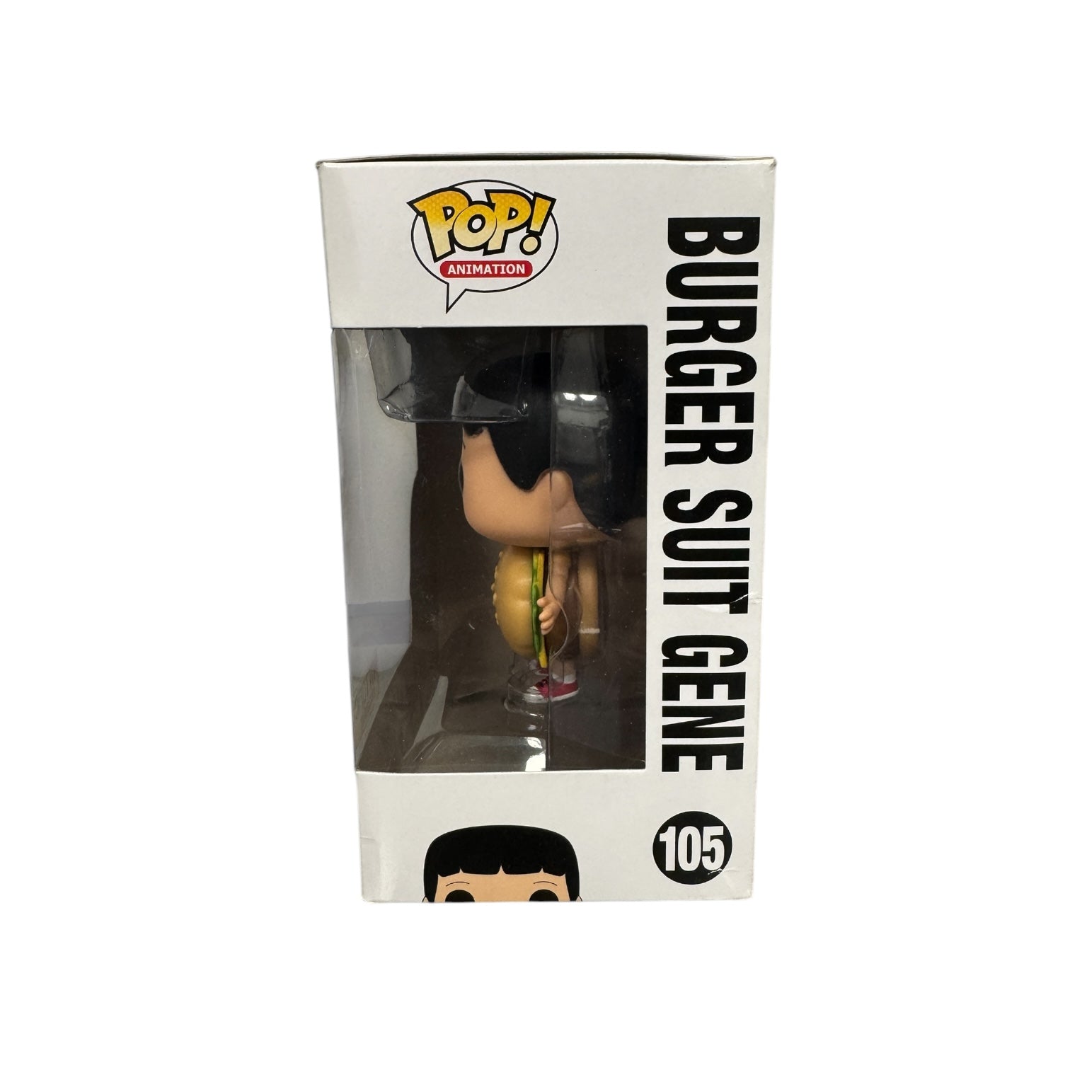 Gene Belcher from Bobs burgers wearing a hamburger costume holding a blue megaphone. Box damage.
