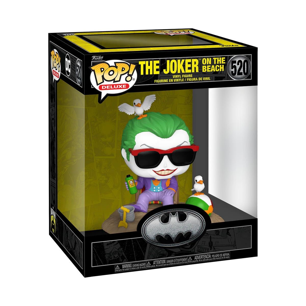 The Joker Funko Pop! Deluxe figure, styled for Batman's 85th anniversary, stands on a sandy beach with vibrant colors.