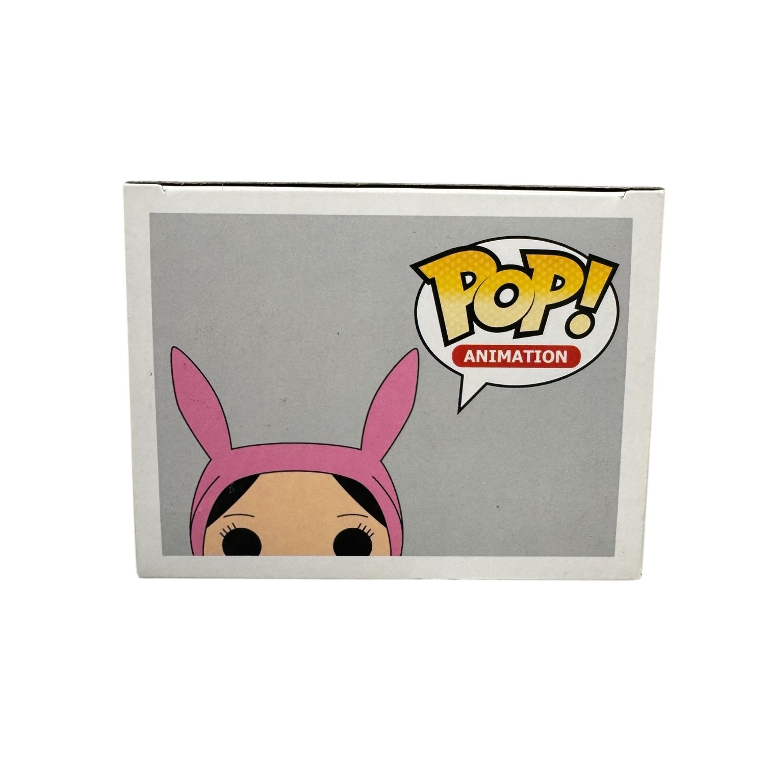 Louise Belcher | Funko Pop | Bob's Burgers . Louise in green dress holding a green teddy wearing pink rabbit ears. 